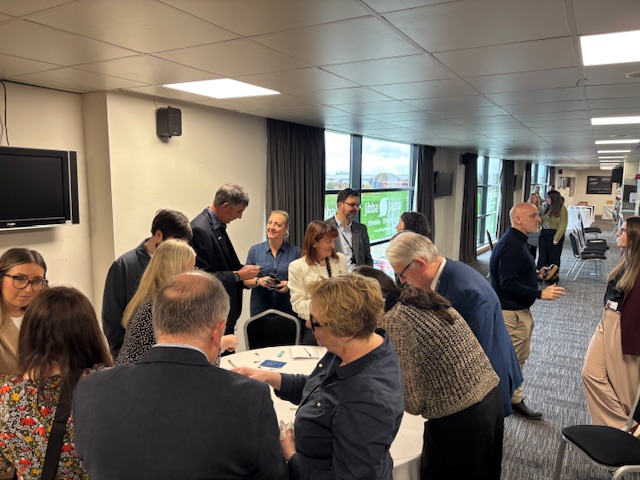 Team Doncaster Partnership Summit event with diverse professionals gathered around a table in a well-lit conference room in Doncaster.
