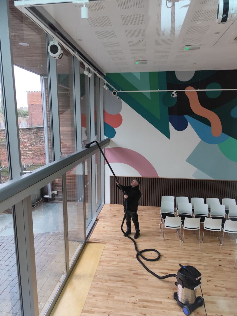 A cleaner uses machine to clean new windows of The Gallery at The Point